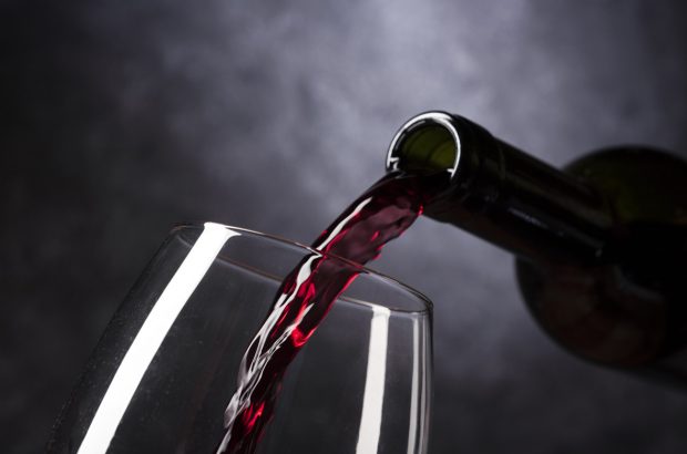 red-wine-pouring-from-bottle-into-glass