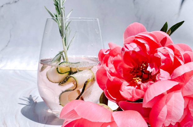 Glass of gin with pink peonies