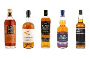 Five bottles of whisky against a white background