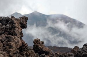 Etna volcano, Sicily, volcanic rock in foreground