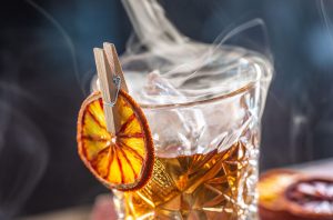 Smoked rum cocktail with orange peel