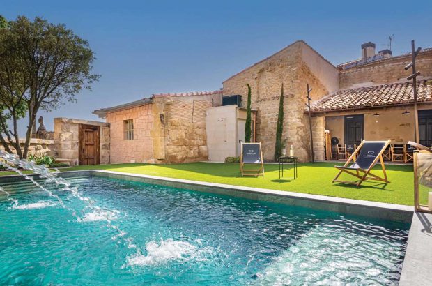 The outdoor pool at boutique hotel Palacio Condes de Cirac in Villalba