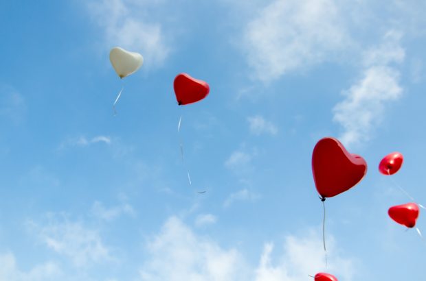 Heart-shaped balloons in the sky