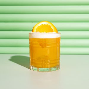 Orange cocktail with a green background