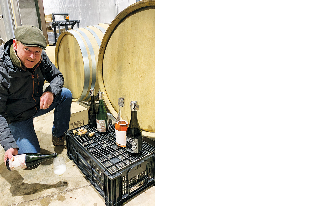 Dermot Sugrue with bottles in cellar