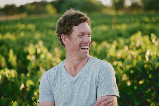 Photo of Nick Farr of By Farr in the vineyard smiling