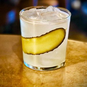 Cocktail with a pickle garnish 