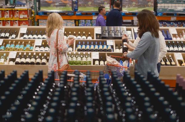 Shoppers peruse the wine aisle at Costco