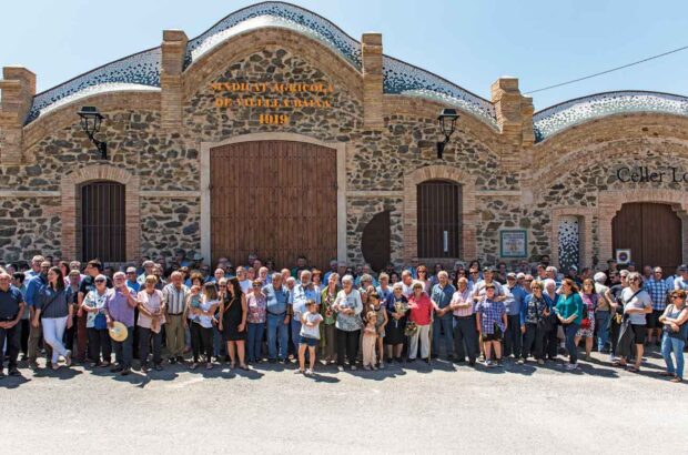 Group of people outside wine cooperative building in Spain