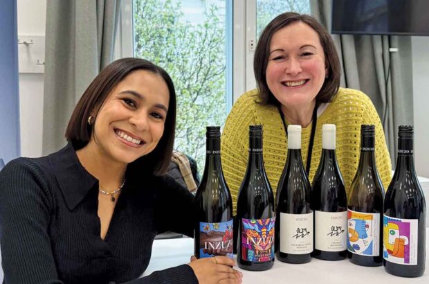 Kaylin Willscott and Julie Sheppard with bottles of wine