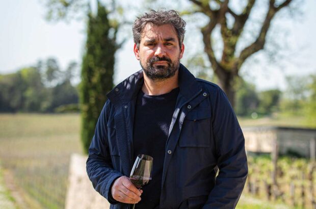 Julien Viaud holding glass of red wine