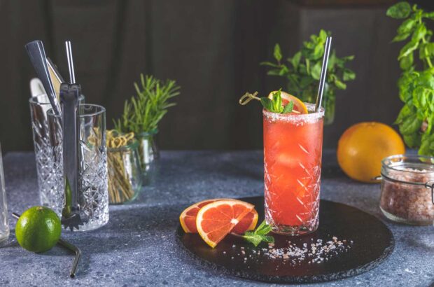 Pink grapefruit Mezcal Paloma cocktail on tray