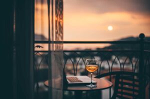 Image of sunset on a balcony with a glass of rosé