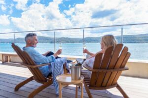 Mature couple drinking champagne out on the deck.