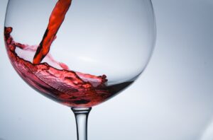 wine being pouring into a glass closeup wine splashing splash