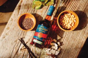 Bottle of Ron Santiago de Cuba Extra Añejo 11 Años on table with spices
