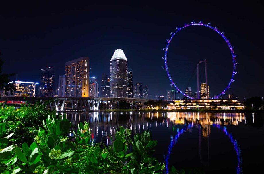 Singapore skyline at night with ferris wheel