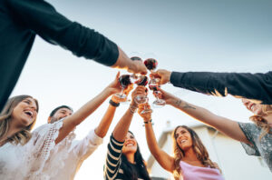 People drinking red wine outside 