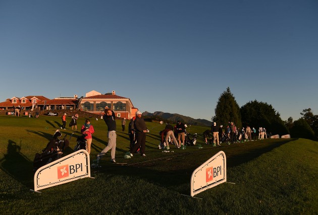 Players practice on the driving range