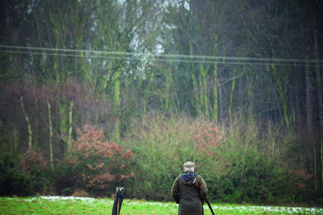 man in field shooting