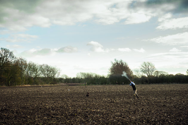 man shooting in winter field