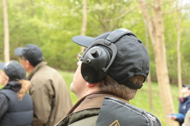man with ear protection in clayshooting field