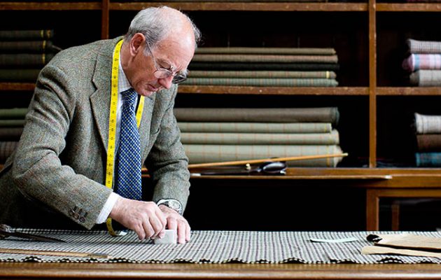 Tailor cutting tweed cloth