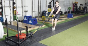 Harlequins' Ross Chisholm does a sled drag