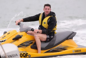 Funny man: Cuthbert enjoys some jetskiing in Noosa