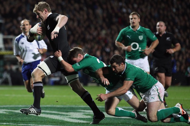 International draw: Adam Thomson drags Irish defenders with him for the All Blacks in 2012