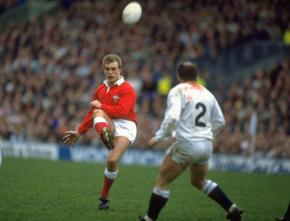 Old enemy: In the red of Wales, Hall chips the ball over England's Brian Moore in 1990