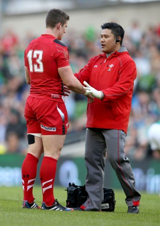Medical man: Prav Mathema (right) at work in another Wales game. Photo: Inpho