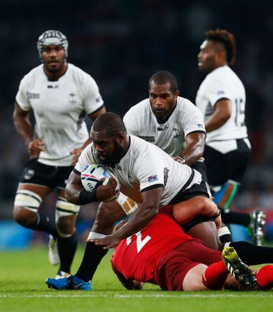 Heavy traffic: Manasa Saulo takes it to England in the RWC opener