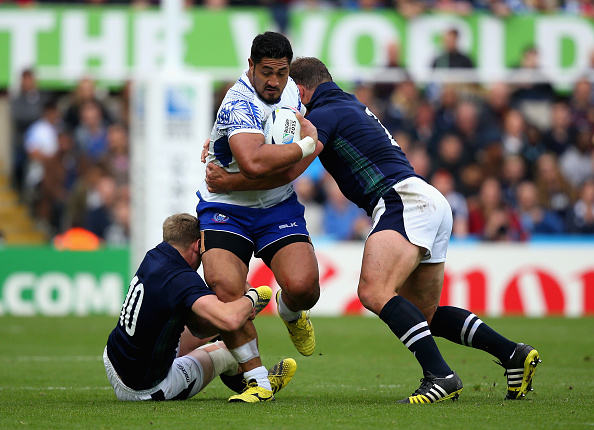 Alafoti Faosiliva of Samoa is tackled by Finn Russell and Ross Ford during Rugby World Cup Pool B match between Samoa and Scotland