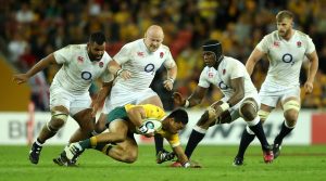 Crowded house: England's forwards swamp Australia centre Christian Lealiifano during England's 39-28 win in Brisbane