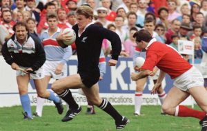 John Kirwan scoots past a Welsh defender