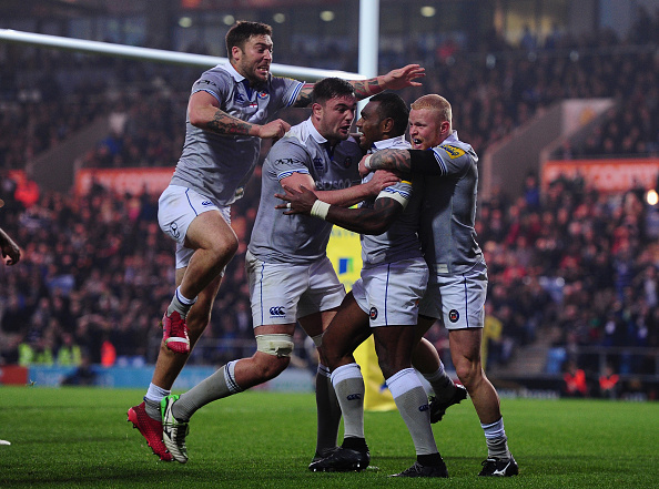 Dance of delight: Bath's players congratulate Rokoduguni on his late try.