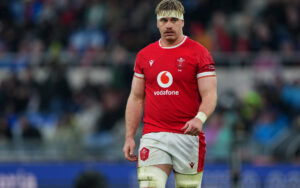 Wales' Aaron Wainwright walks across the pitch in the 2025 Six Nations match against Italy.