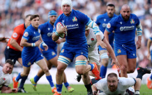 Italy's Manuel Zuliani running with the ball in the Six Nations 2025 match against England.