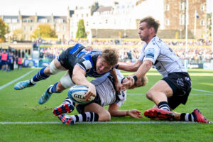 Bath Rugby's Ted Hill stretches to touch the ball down during the October 2024 match against Bristol Bears.