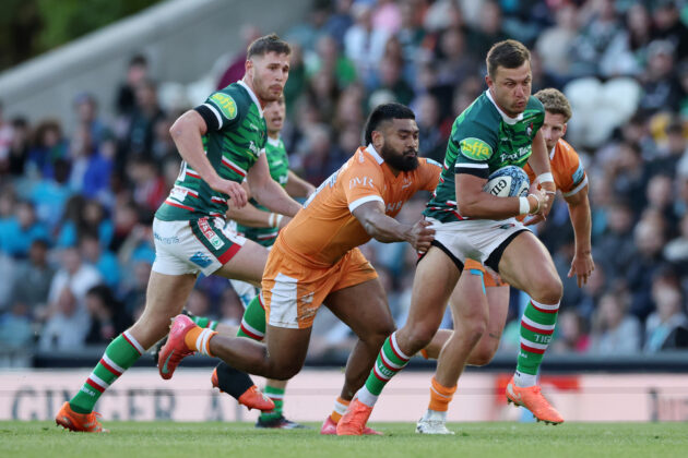 Leicester Tigers' Handre Pollard runs with the ball, evading the tackle of Sale Sharks’ Rekeiti Ma'asi-White