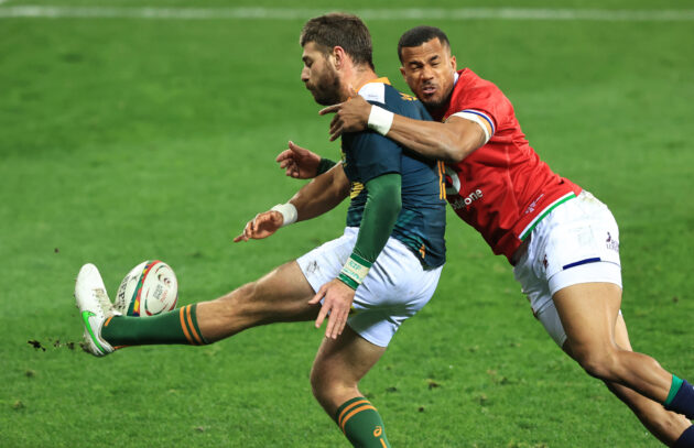 Willie Le Roux kicks for South Africa A as the British & Irish Lions’ Anthony Watson attempts a tackle.