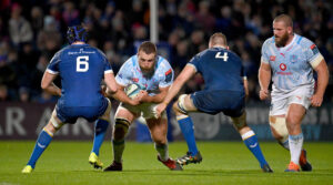 Gerhard Steenekamp of the Bulls carries the ball into contact with Leinster's Ryan Baird and Ross Molony.