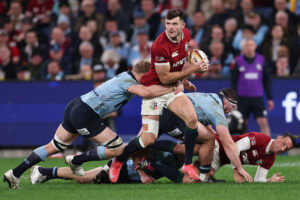 The British & Irish Lions’ Blair Kinghorn evades a tackle during his team's 2025 match against NSW Waratahs