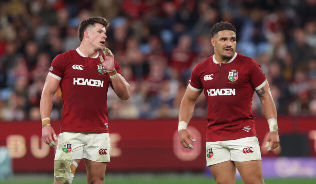 British & Irish Lions players Huw Jones and Sione Tuipulotu standing side by side during the 2025 match against NSW Waratahs.