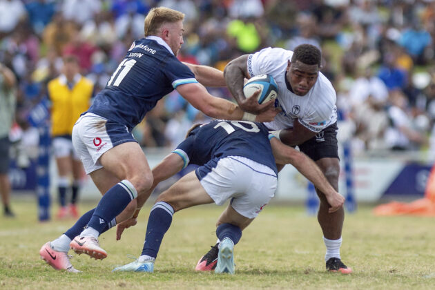 Kyle Steyn and Fergus Burke of Scotland tackle Josua Tuisova of Fiji during the July 2025 international