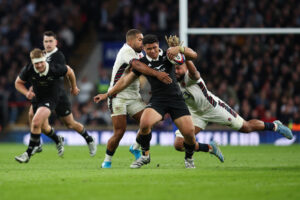 England's Chandler Cunningham-South and Ollie Lawrence tackle New Zealand's Caleb Clarke during the 2024 November internationals