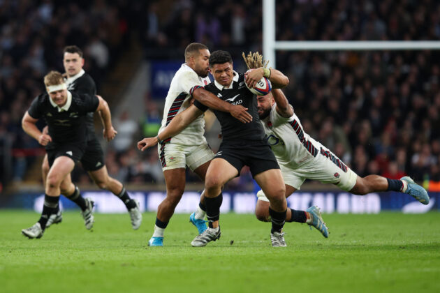 England's Chandler Cunningham-South and Ollie Lawrence tackle New Zealand's Caleb Clarke during the 2024 November internationals