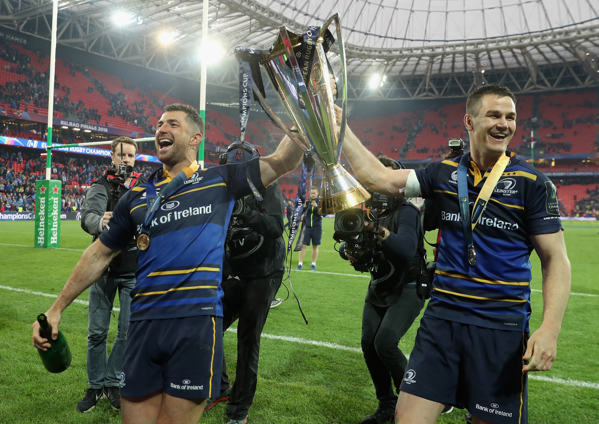 Leinster's Rob Kearney and Jonathan Sexton walk on the pitch with the European Champions Cup after their 2018 final victory.