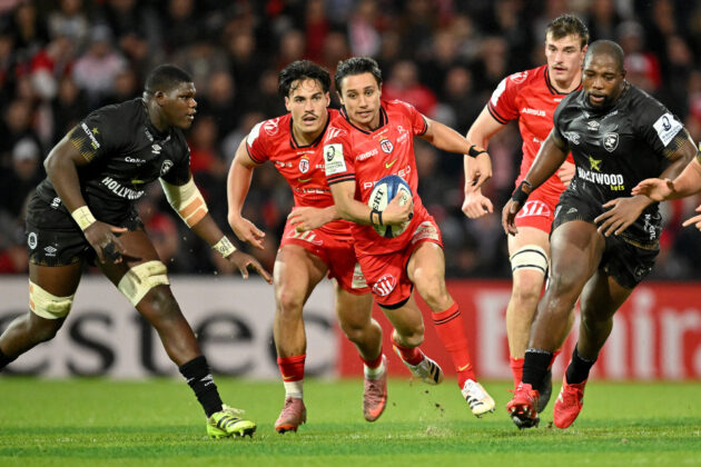 Toulouse's Ange Capuozzo beats Sharks defenders during the December 2025 European Champions Cup match
